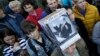 A protester wearing a hat depicting Russian President Vladimir Putin and reading "Putin Means Stagnation" during a rally against pension reform in St. Petersburg on September 16.