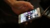 IRAN -- A man works on his cell phone at an internet cafe in Tehran, July 25, 2019