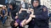 Riot police detain a man during an anticorruption protest on Tverskaya Street in Moscow. Protest organizer Aleksei Navalny has faced criticism for moving the demonstration to the Russian capital's central thoroughfare at short notice. 
