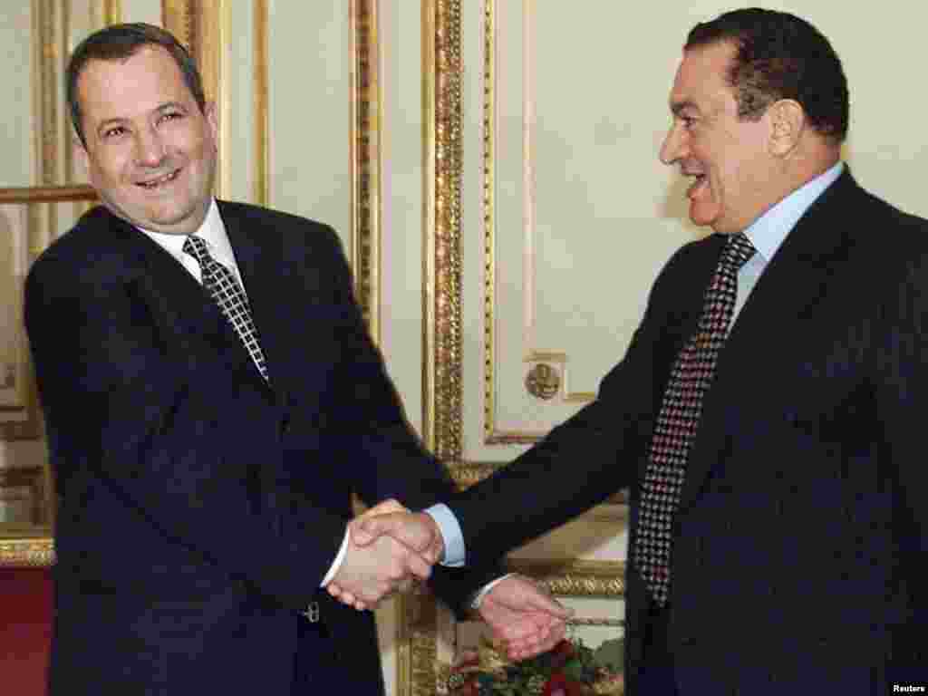 Mubarak and Israeli Prime Minister Ehud Barak shake hands before a meeting in Paris in November 1999.