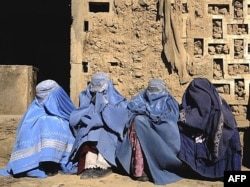 Widows wait for their food rations at an aid distribution center in Kabul before the Taliban takeover.
