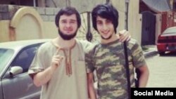 Chechen Islamic State militant DjunduLlah (right) poses with a fellow militant in photo posted to his ask.fm account. DjunduLlah complains that there are no women for him to marry.