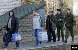 Ukrainian war prisoners are guarded by Luhansk separatists during a prisoner exchange in February 2016.