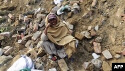 A Pakistani woman waits for news of her son missing under the rubble of a factory on the outskirts of Lahore that collapsed on November 4. 