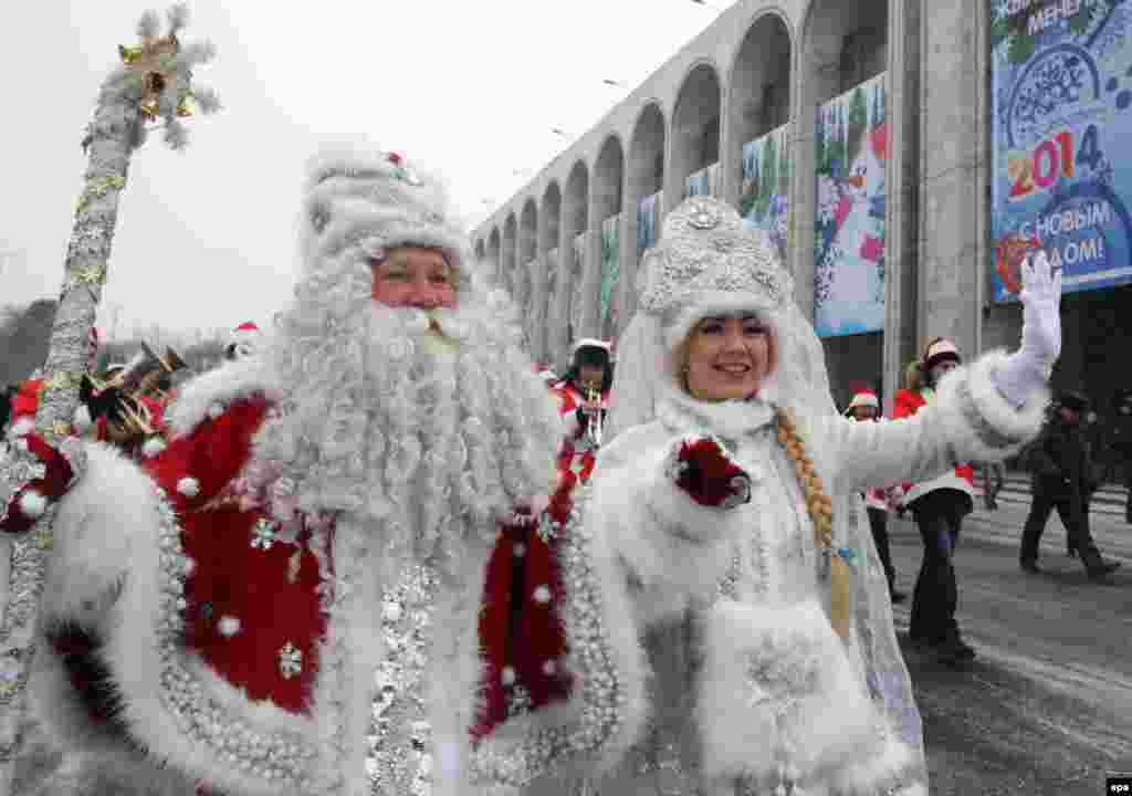 Father Frost (left) and his granddaughter the Snowmaiden take part in a New Year&#39;s parade in Bishkek, Kyrgyzstan, on December 31. (epa/Igor Kovalenko)