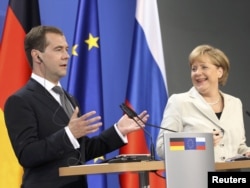 German Chancellor Angela Merkel (right) and Russian President Dmitry Medvedev hold a news conference following talks in Hanover in July 2011.