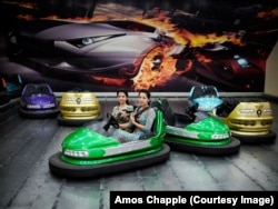 Young twins strap in for a bumper car ride inside a shopping center in the capital, Ashgabat.