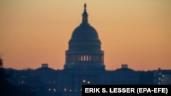 U.S. -- A man walks on the National Mall in front of the U.S. Capitol building at dawn in Washington, DC, U.S., December 27, 2018