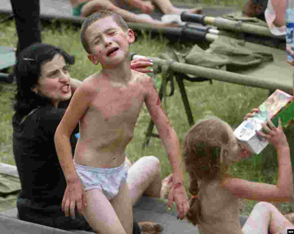 A boy cries among other freed hostages after special forces entered the school on September 3, 2004. A number of witnesses also say they saw tanks fire on the school. Independent investigators have denounced what they say was a botched rescue operation.