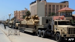 Egyptian military trucks loaded with light tanks line up in el-Arish ahead of an operation to restore security in northern Sinai. 