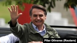 File photo:BRAZIL -- Jair Bolsonaro, far-right lawmaker and presidential candidate of the Social Liberal Party (PSL), gestures at a polling station in Rio de Janeiro, Brazil October 28, 2018