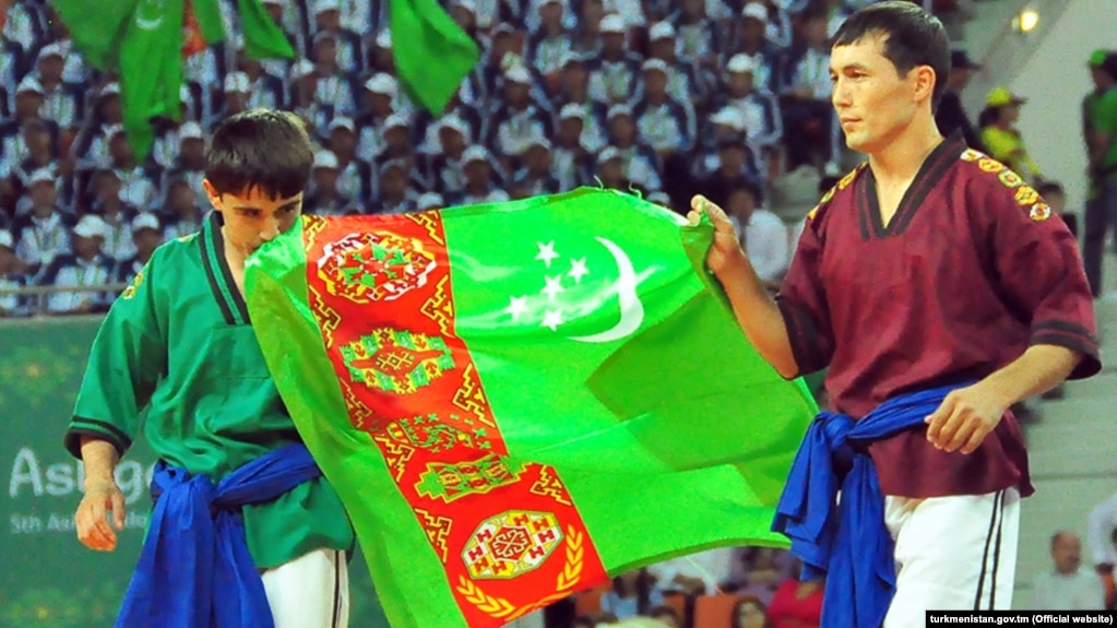 Turkmen wrestlers carry the national flag at the opening ceremony of the Asian Indoor and Martial Arts Games in Ashgabat on September 17.