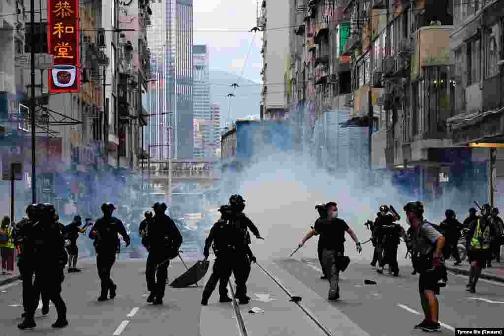 Riot police fire tear gas into the crowds to disperse anti-national security law protesters during a march at the anniversary of Hong Kong's handover to China from Britain in Hong Kong, China July 1, 2020. REUTERS/Tyrone Siu 