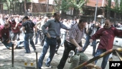 Georgian riot police clash with opposition protesters in Tbilisi in mid-June.