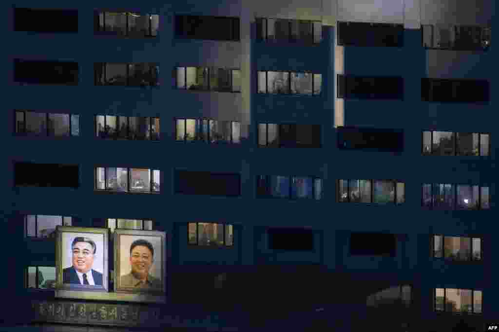 Portraits of late North Korean leaders Kim Il Sung (left) and Kim Jong Il are displayed on the side of a building in Pyongyang. (AFP/Ed Jones)