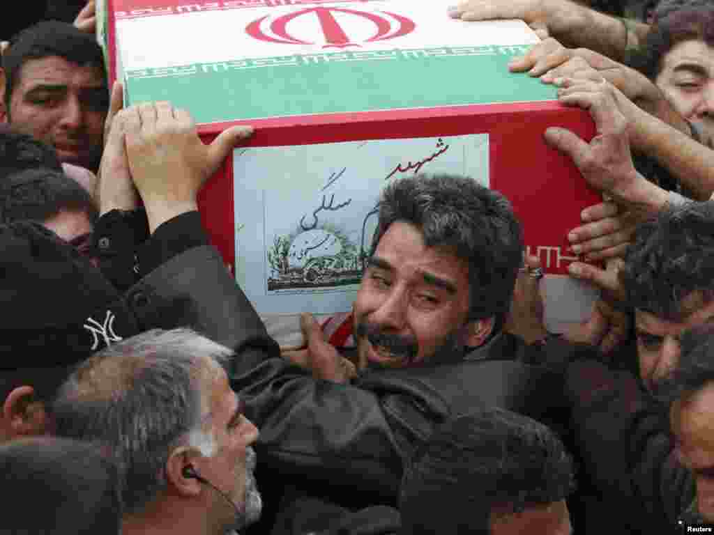 A man reacts as he carries the coffin on November 14 of a member of Iran&#39;s Islamic Revolutionary Guards Corps who was killed during a blast in a military base near Tehran. (REUTERS/Jamejam Online/Ebrahim Norouzi)