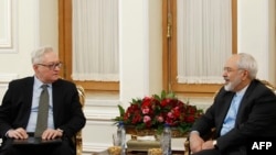 Iranian Foreign Minister Mohammad Javad Zarif (R) meets with Russian deputy foreign minister Sergei Ryabkov in Tehran, January 12, 2015