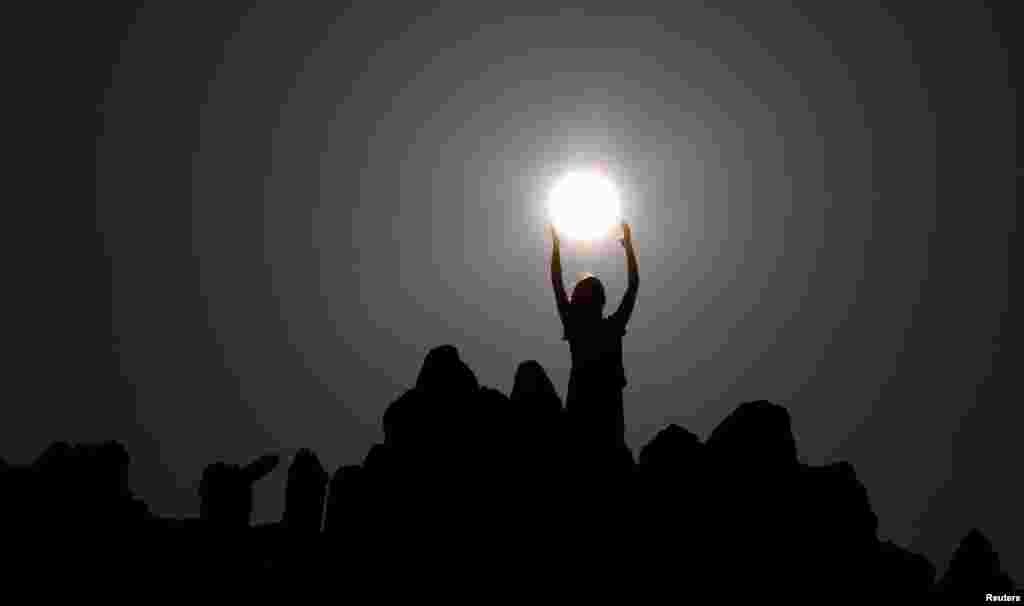 People celebrate the summer solstice at the Kokino megalithic observatory, near the city of Kumanovo, Macedonia, on June 21. (Reuters/Ognen Teofilvovski )