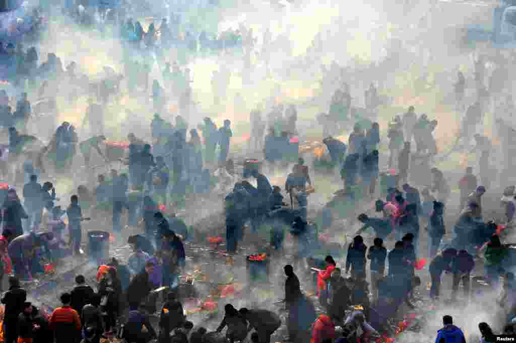 People burn incense to worship the god of fortune on the fifth day of the Chinese Lunar New Year in Hubei Province on February 12. (Reuters)