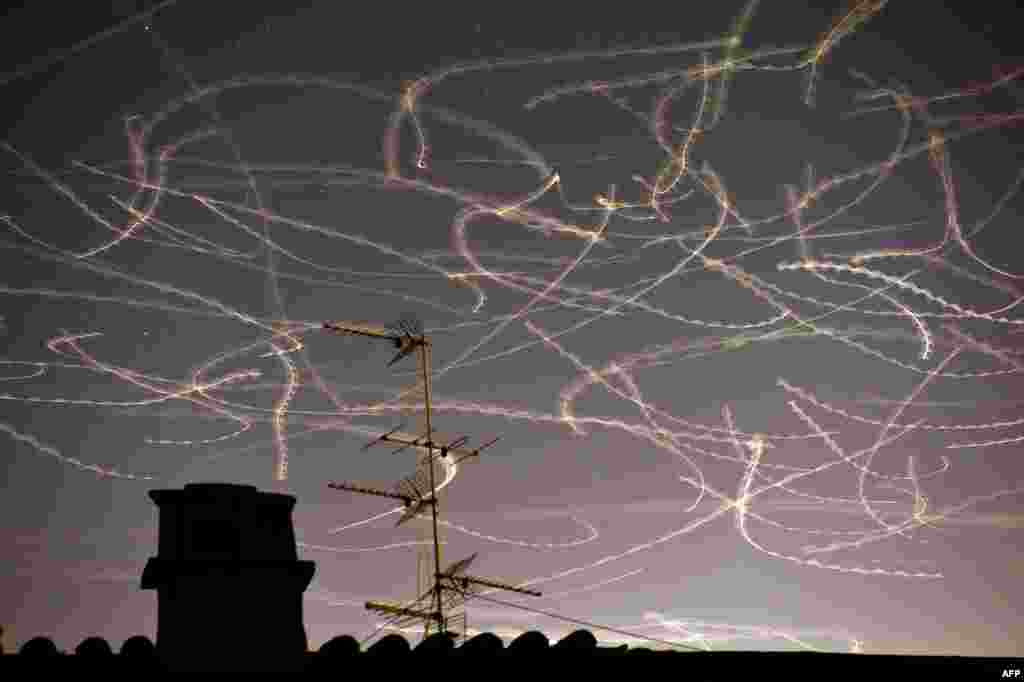 This picture taken with a slow exposure shows seagulls flying in the sky over Rome. (AFP/Gabriel Bouys)