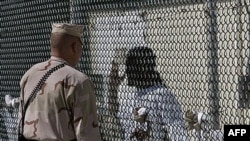 How can the inmates at Guantanamo be tried, and where can they be released?