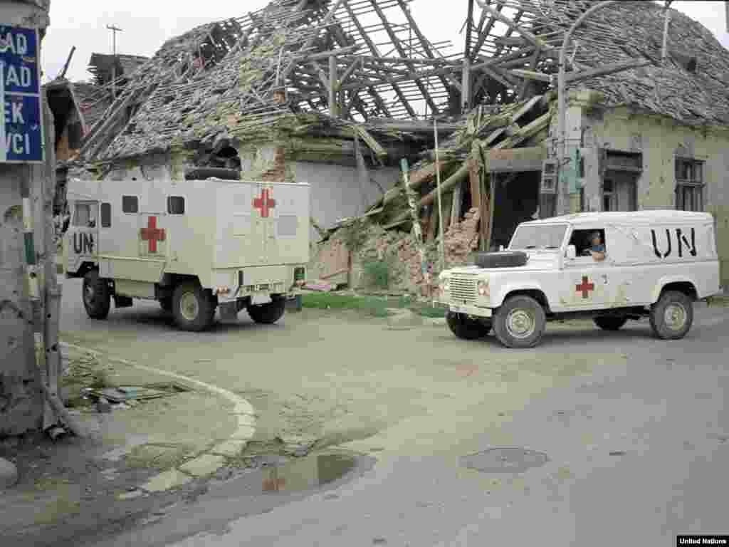 Ambulances from the British contingent of UNPROFOR move through the streets of Vukovar, July 1992.