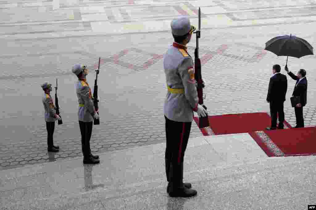 National guards and Tajik Foreign Minister Sirodjidin Aslov (second from right) wait to welcome U.S. Secretary of State John Kerry at the Palace of Nations in Dushanbe, Tajikistan. Kerry is on a tour of the five Central Asian nations. (AFP/Brendan Smialowski)