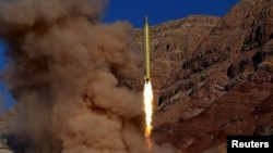 A ballistic missile is launched at an undisclosed location in this handout photo released by Fars news on March 9.