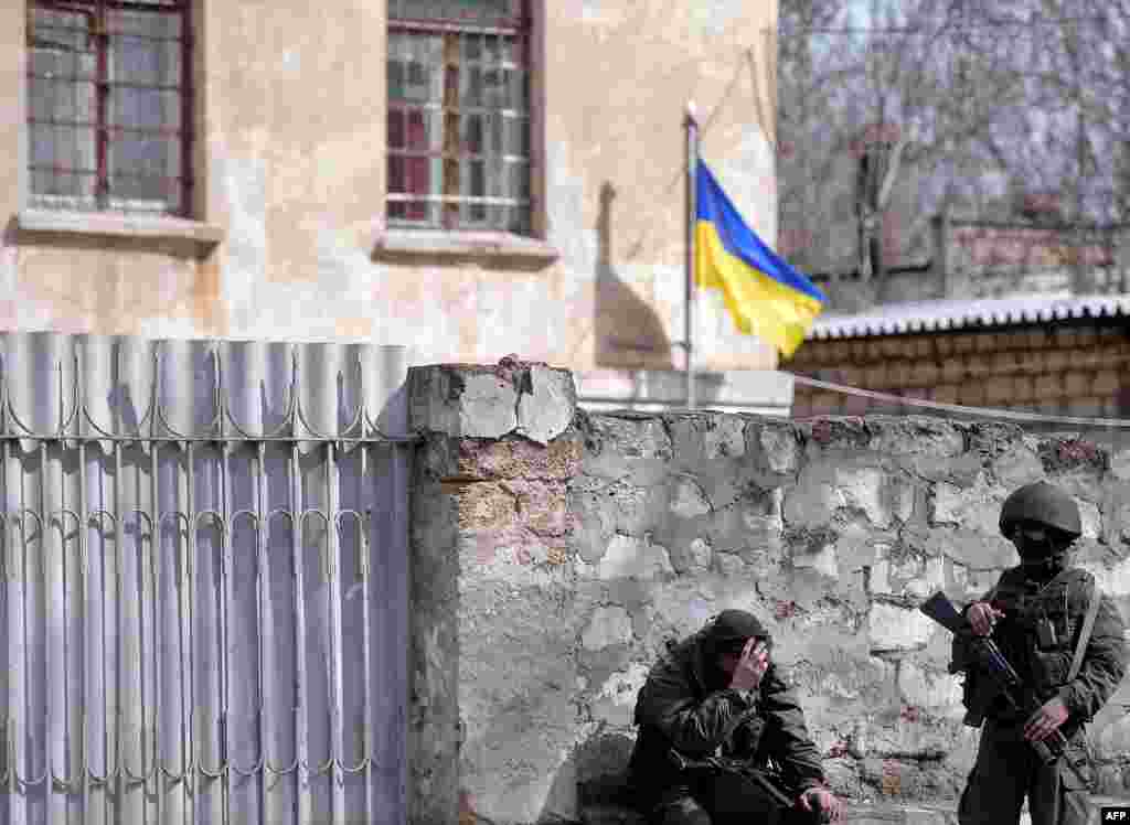 Ukraine -- Crimea - Russian soldiers patrol near the Ukranian navy headquarters in Simferopol on March 18, 2014.