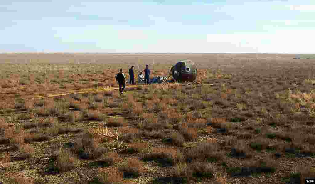 A search-and-rescue team works at the landing site on the desolate Kazakh steppes of the Soyuz MS-10 space capsule after a launch to the International Space Station (ISS) was aborted due to a problem with a booster rocket. The crew of two landed safely after what is called a &quot;ballistic descent.&quot; (TASS)