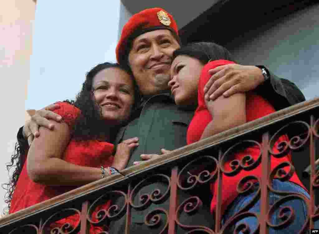 Chavez embraces his daughters Maria (left) and Rosa at the Miraflores Palace in Caracas in July 2011.