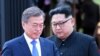 North Korea's leader Kim Jong Un (L) and South Korea's President Moon Jae-in (R) walk to announce a joint statement after a signing ceremony near the end of their historic summit at the truce village of Panmunjom on April 27, 2018.