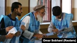 Afghan election commission workers in Kabul prepare ballot papers for counting after the country's presidential election on September 28. 