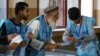 Afghan election commission workers count ballot papers from the September 28 presidential election in Kabul.