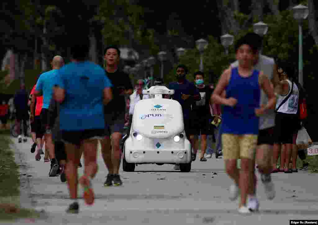 Public Utilities Board&rsquo;s (PUB&rsquo;s) O-R3 social distancing ambassador robot broadcasts reminders at joggers to keep a safe distance during the coronavirus (COVID-19) outbreak in Singapore April 27, 2020.