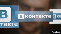 A man in Moscow looks at a computer screen showing logos of Russian social network VKontakte.