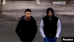 Paris shooting suspect Salah Abdeslam (left) and suspected accomplice Hamza Attou are seen at a filling station on a highway between Paris and Brussels, in Trith-Saint-Leger, France in this still image taken from a November 14, 2015, video.