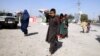 People flee amid ongoing fighting between government forces and Taliban militants, in Kunduz, on October 6.