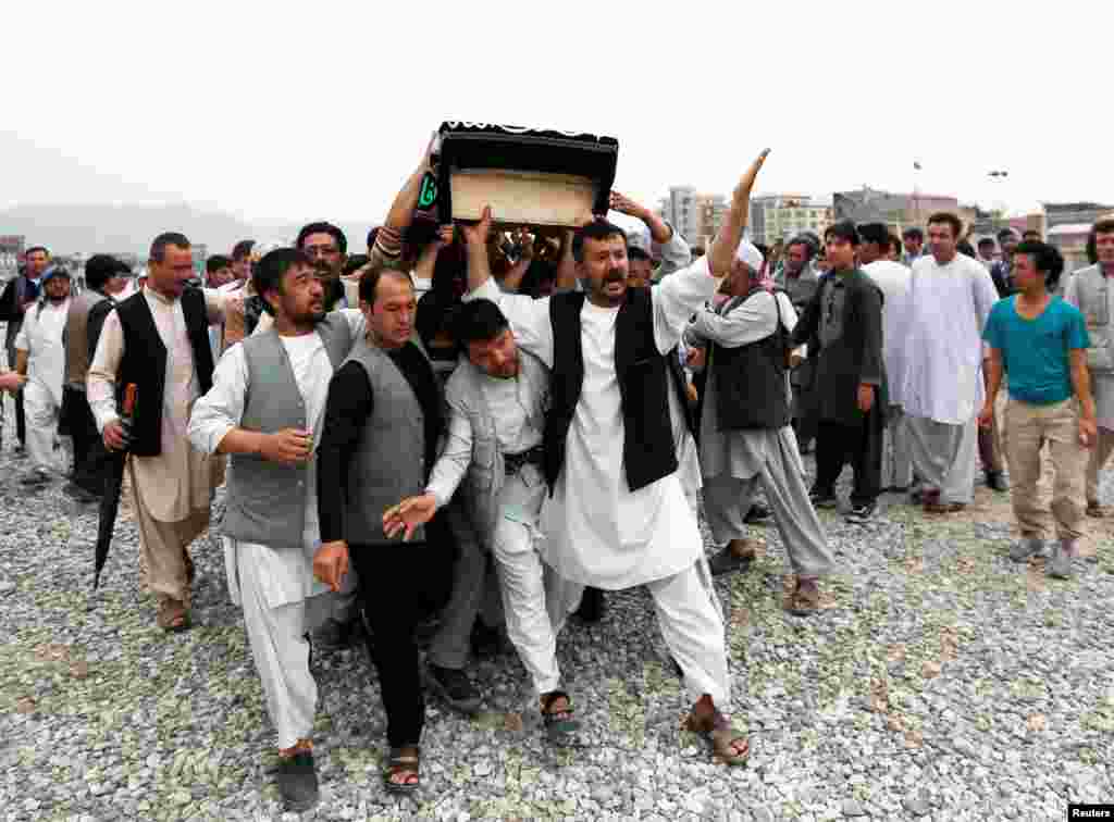 Men carry the coffin of one of the victims of a suicide attack in Kabul, Afghanistan, which killed more than 80 people on July 23. (Reuters/Mohammad Ismail)