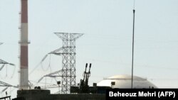 An anti aircraft machine-gun is seen in front of the reactor building of the Bushehr nuclear power plant, February 26, 2018