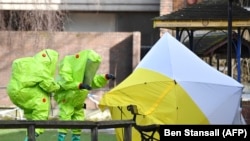 U.K. investigators examine the site in Salisbury where Sergei and Yulia Skripal were found poisoned in March. (file photo) 