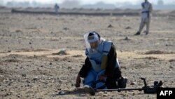 Security personnel clear mines from a field in Afghanistan, which is one of the most heavily mined countries in the world. (file photo)