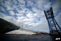 Спустя год после катастрофы Costa Concordia все еще лежит на мелководье у берегов острова Джильо
