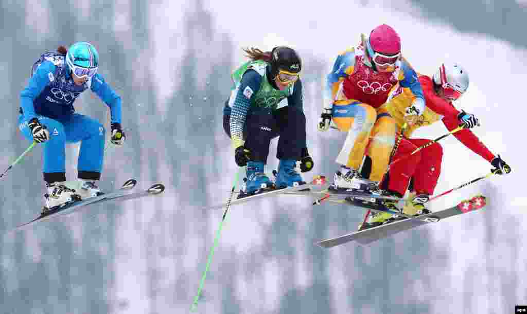 Women skiers compete in the small final of the women's freestyle ski-cross event. (epa/Daniel Karmann)