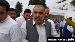 Asad Qaiser arrives to attend the first session of the lower house of parliament in Islamabad on August 13.