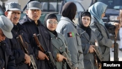 Male and female Afghan National Police officers line up before a drill at a training center in Mazar-e Sharif. Less than 1 percent of police officers are women.