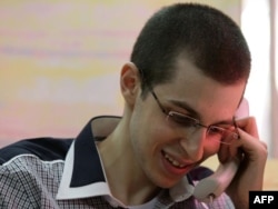 Israeli soldier Gilad Shalit speaks with his family on the telephone.