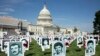 Activists opposing the government of Iran place the images of alleged victims of state-sponsored executions of political prisoners in 1988 in Iran, on the East Front of the US Capitol in Washington, September 12, 2019