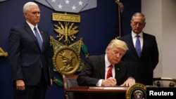 U.S. President Donald Trump signing his executive order on travel