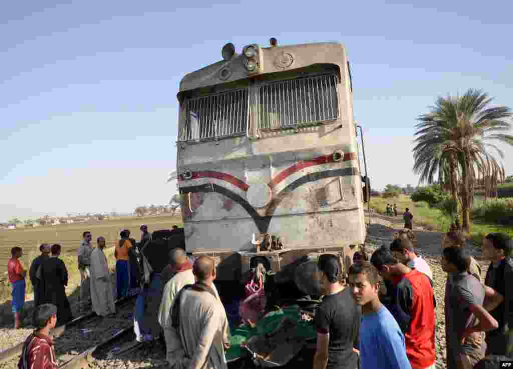 People inspect a train involved in a horrific accident in the province of Assuit, south of Cairo. Forty-seven nursery school children were killed when the train struck their bus on November 17. Transport Minister Rashad al-Metini resigned in the wake of the tragedy, saying he "accepts responsibility" for the accident. Egyptian President Muhammad Morsi has also accepted the resignation of the Egyptian Railway Authority head. (AFP)
